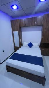 a bedroom with a bed with blue lights on it at Grand Stay Hotel in Seeduwa