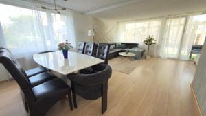 a living room with a dining table and chairs at Basel Haven in Münchenstein