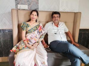 a man and a woman sitting on a couch at Hotel Radhika Palace in Raipur