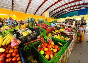 a produce section of a grocery store with fruits and vegetables at TI kasa cherry in Le Diamant