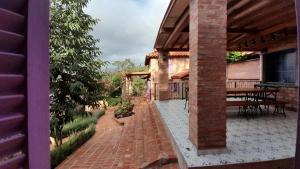 an outside view of a house with a brick patio at Cabaña Las Lavandas in Samaipata