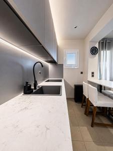 a kitchen with a sink and a counter at Infinity Beach House by KLV in Argostoli +40 photos