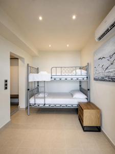 a bedroom with two bunk beds in a room at Infinity Beach House by KLV in Argostoli