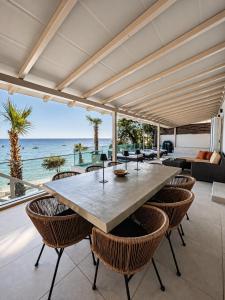 an open living room with a large table and chairs at Infinity Beach House by KLV in Argostoli