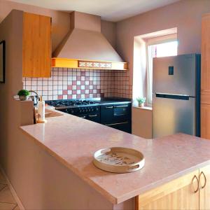 a kitchen with a counter top with a refrigerator at Casa ai Tre Colli, Tres in Tres