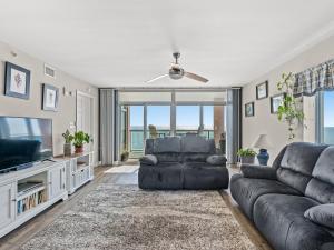 a living room with a couch and a television at Crescent Beauty in Myrtle Beach