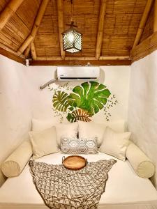 a room with a rattan couch and a table at Hotel Puerto Antiguo in Los Órganos
