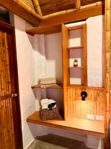 a room with a wooden cabinet with a basket at Hotel Puerto Antiguo in Los Órganos
