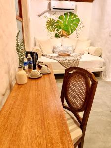 a table and a chair and a couch in a room at Hotel Puerto Antiguo in Los Órganos +128 photos