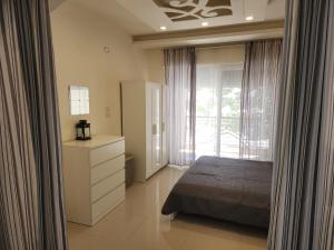 a bedroom with a bed and a large window at Al-Amaari Gardens Compound 3092 in Irbid +22 photos