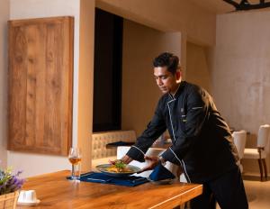 a man standing at a table with a plate of food at Tombolo Bay in Dickwella +28 photos