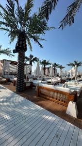 a palm tree sitting on top of a wooden deck at Hotel AVALON in Nesebar