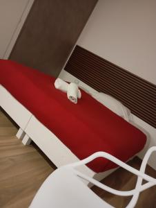 a red and white bed in a room at Borgo Mantova in Potenza