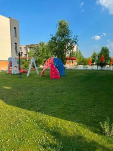 a park with play equipment in the grass at Beside Gardens in Otopeni