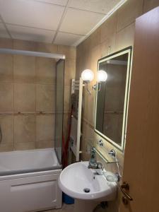 a bathroom with a sink and a bath tub at First Choice Apartment in Skopje +22 photos