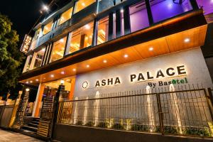 an asia palace hotel is lit up at night at Hotel Asha Palace By Basotel in Deoghar