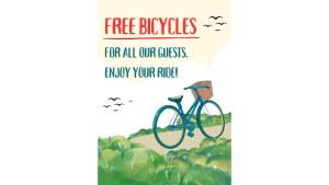 a bike parked in a field with the words free bicycles for all our cyclists happy at You And Me Guesthouse in Cha Am