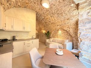 a kitchen and living room with a table and chairs at Opus Luxury Maisonette in Chios +15 photos