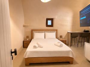 a bedroom with a bed with two towels on it at Opus Luxury Maisonette in Chios