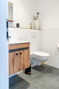 a white bathroom with a toilet and a sink at Ferienwohnung 1 Gasthaus Bußmann Vreden in Vreden +19 photos