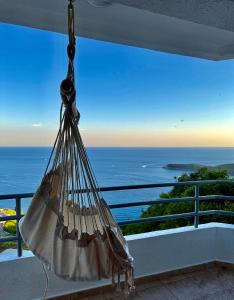 a hammock hanging from a balcony with a view of the ocean at Sea Time Apartment in Budva