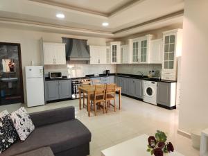 a large kitchen with a table and a couch at Al-Amaari Gardens Compound 3091 in Irbid