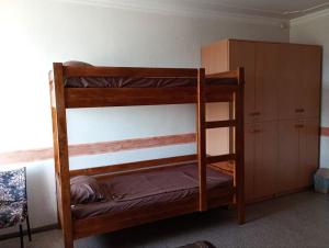 two bunk beds in a room with a cabinet at Hostel COMFORT in Mukacheve