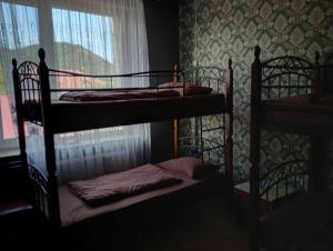 two bunk beds in a room with a window at Hostel COMFORT in Mukacheve