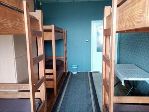 a room with two bunk beds and a hallway at Hostel COMFORT in Mukacheve