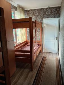 a room with two bunk beds and a door at Hostel COMFORT in Mukacheve +1 photo