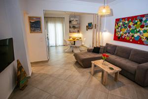 a living room with a couch and a table at Anastasios' artwork apartment in Thessaloniki