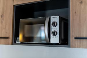 a microwave oven sitting inside of a cabinet at Ferienwohnung 2 Gasthaus Bußmann in Vreden +10 photos