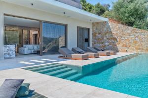 a villa with a swimming pool and a house at Deciel Cave Villa in Áyios Pétros