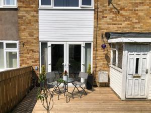 a patio with a table and chairs next to a building at Koti in Murton +8 photos