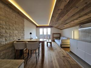 a kitchen and living room with a table and chairs at Attique de la Moubra 4 in Crans-Montana