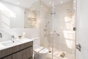 a bathroom with a shower and a toilet and a sink at City Center R3 in Nerja