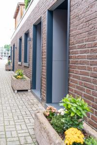 a brick building with blue doors and some flowers at Ferienwohnung 3 Gasthaus Bußmann in Vreden +7 photos