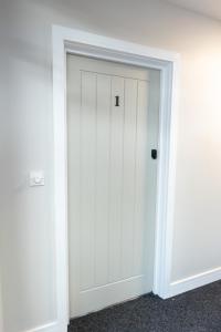 a white door in the corner of a room at 1 Bed City Studio near Theatre and Station Secure Parking in Hull