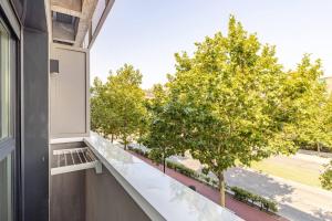 an apartment with a balcony with trees at Studio Europa 30 in San Sebastián de los Reyes