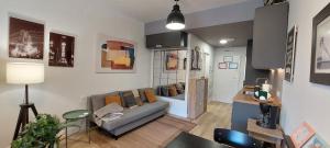 a living room with a couch and a table at Studio Europa 30 in San Sebastián de los Reyes