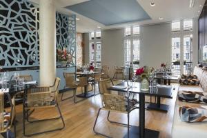 a restaurant with tables and chairs and windows at Best Western Grand Hotel de Castres in Castres
