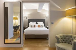 a hotel room with a bed and a mirror at Best Western Grand Hotel de Castres in Castres +61 photos