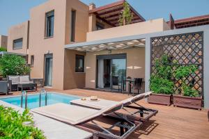 a villa with a swimming pool and a house at Villa Andrea in Elounda