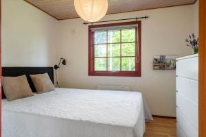 a bedroom with a white bed and a window at LF12118-Vinderup-Vigen-18 in Handbjerg