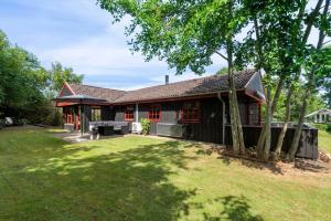 a house with a large yard in front of it at LF12118-Vinderup-Vigen-18 in Handbjerg