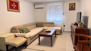 a living room with a couch and a table at Wild silence - Skadar Lake in Virpazar