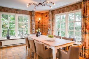 a dining room with a wooden table and chairs at De Bron | 1-8 pers. in Losser +28 photos