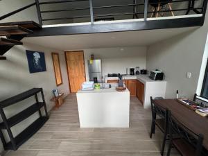 a kitchen with a white counter top in a room at Nani House in Montezuma