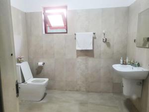 a bathroom with a toilet and a sink at Dee Holidays in Moratuwa +18 photos