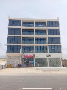 a large building with a store in front of it at صلالة مرباط in Mirbāţ
